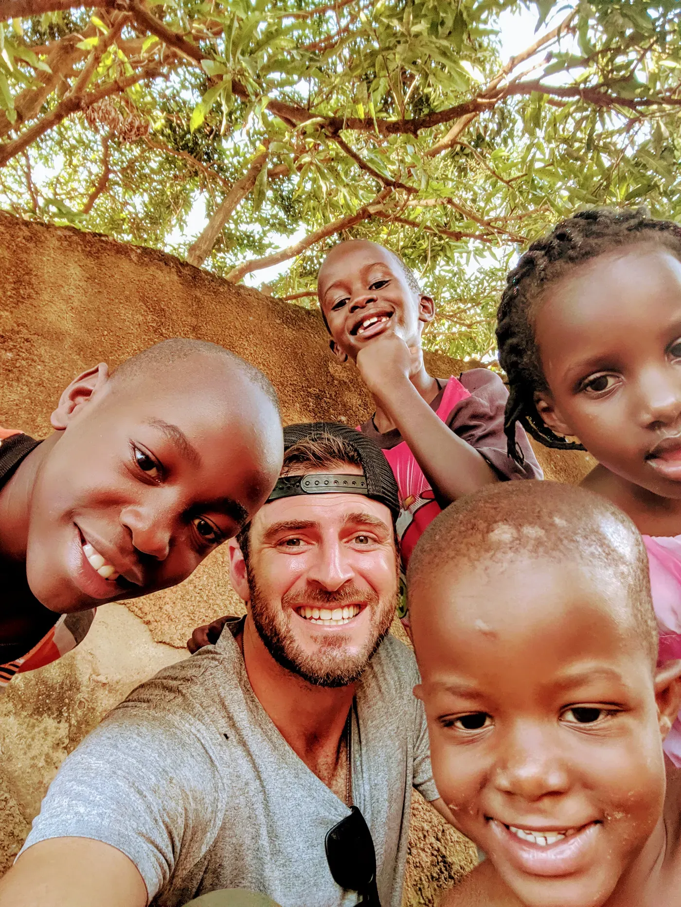 Children crowding into a photo with Grant