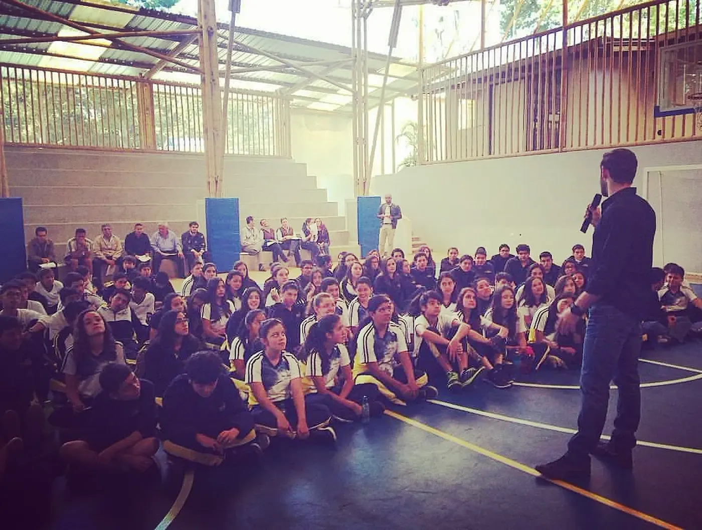 Grant addressing a school hall packed with students